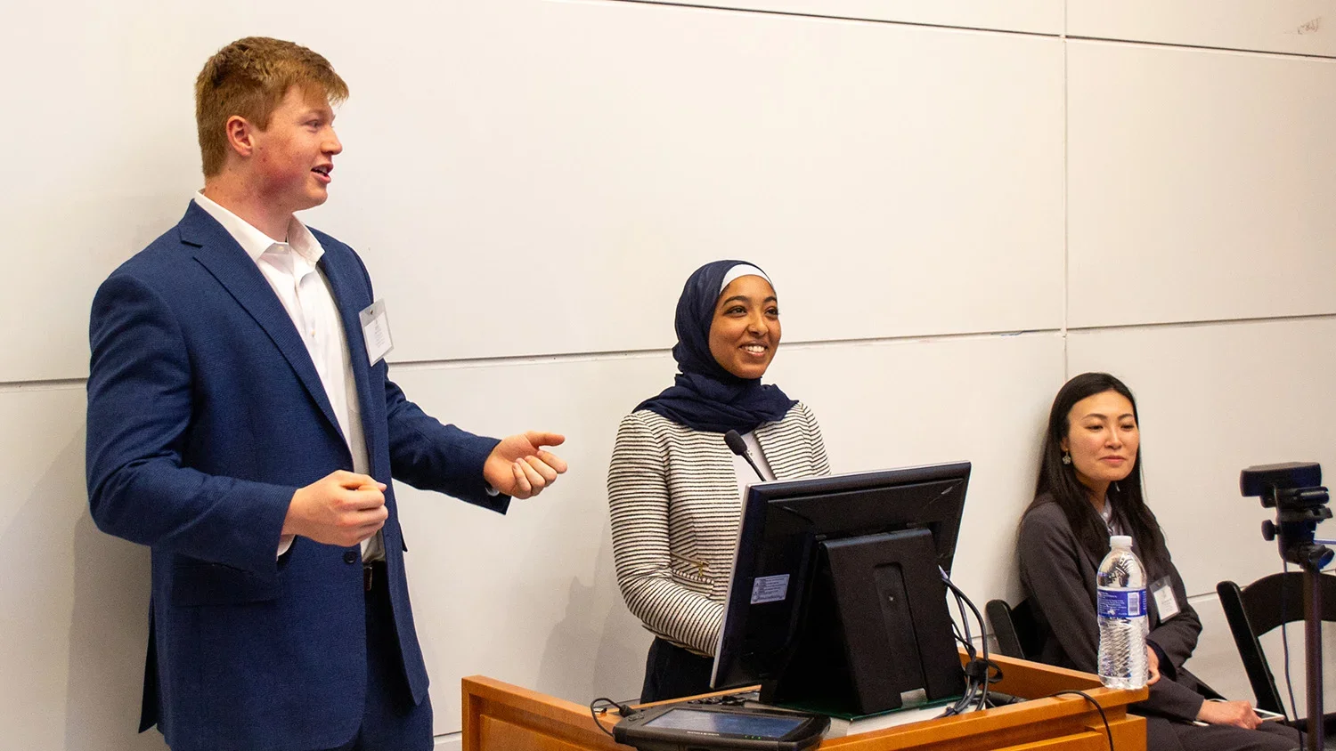 Student presenters stand at the podium during the "Food as Medicine" conference